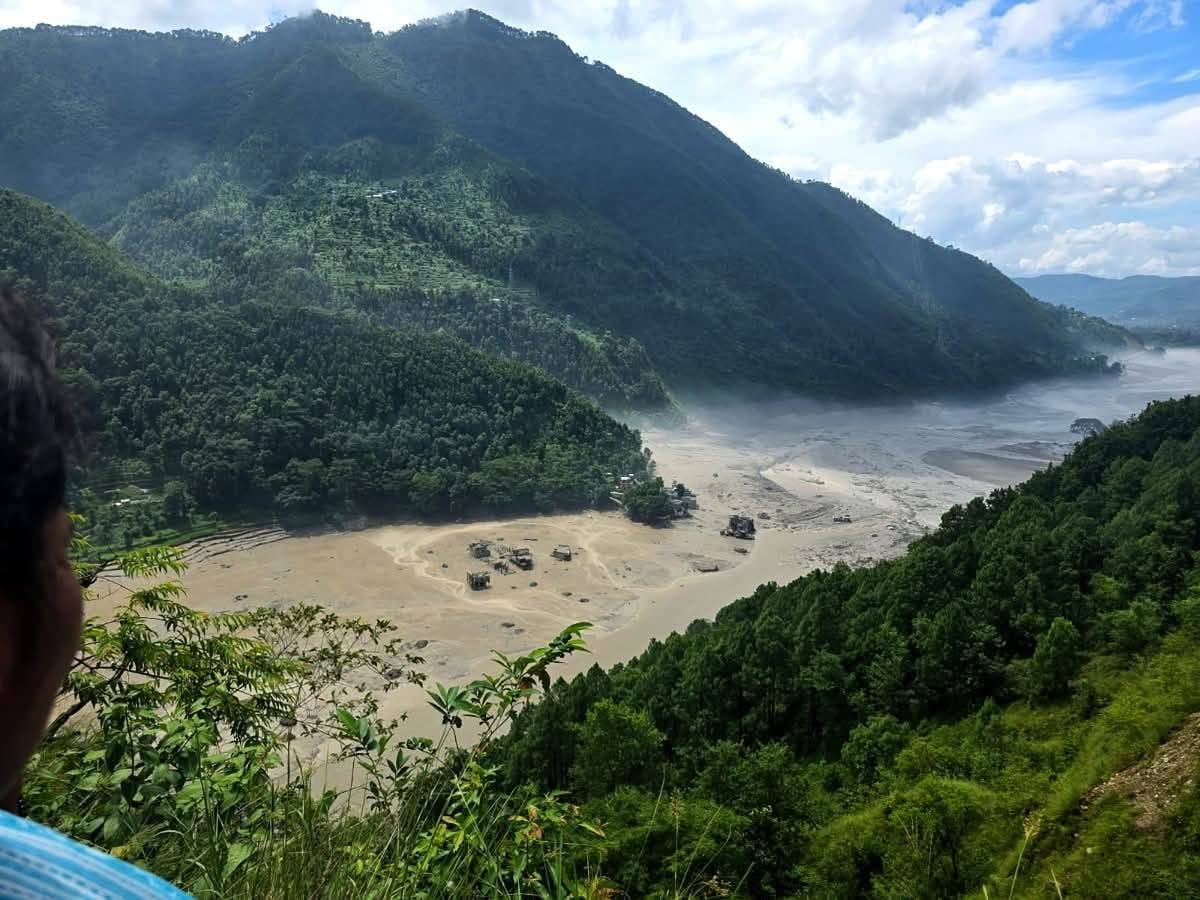 A wide fan of silt and destroyed houses across the valley floor